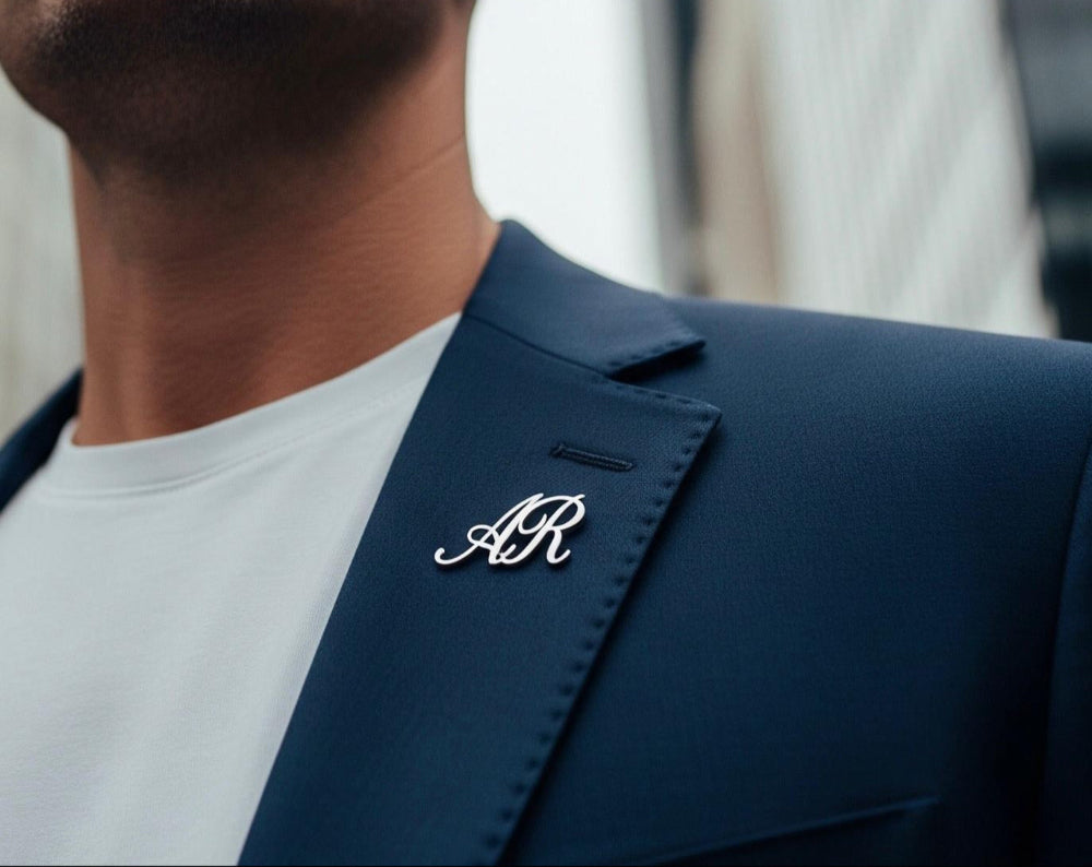 Silver lapel pin with AR letters
