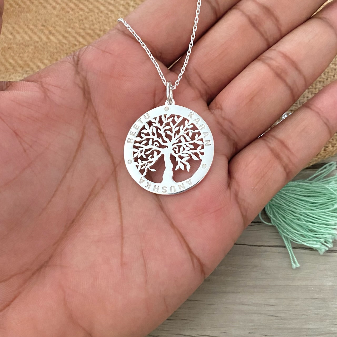 Silver necklace with family tree and names