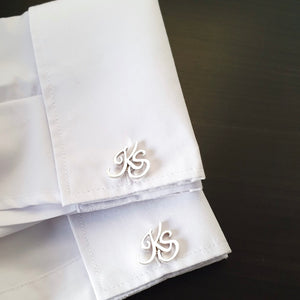 Customized cufflinks with cursive initials. 